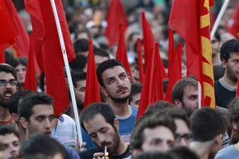Greek communists gather in Athens Thursday to rally against the government's austerity measures. Prime Minister George Papandreou vowed to stay on...