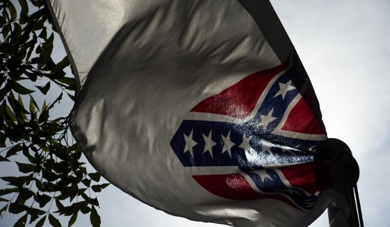 A Confederate flag flies next to the Alabama Confederate Memorial on the grounds of the Alabama Capitol building in Montgomery, Ala., Monday, June 22, 2015. (Albert Cesare/The Montgomery Advertiser via AP)  NO SALES; MANDATORY CREDIT