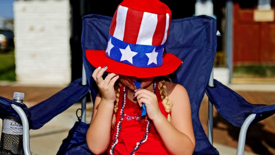 FILE -- Hannah Hargis enjoys a snack as she watches the LibertyFest Fourth of July Parade in Edmond, Okla.