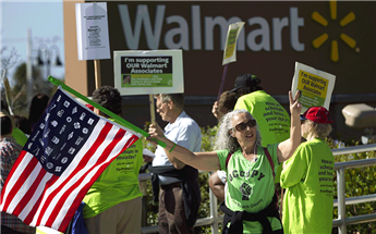 Wal-Mart employees and union supporters rally for better pay and benefits outside a store in Boynton Beach, Fla., on Nov 23, 2012.  AP